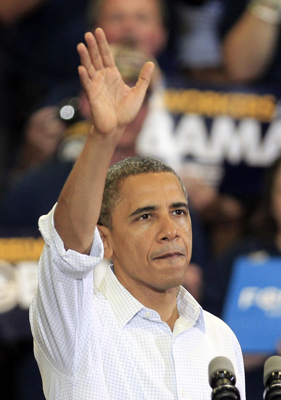 President Barack Obama waves to supporters after speaking at a campaign event at Scott High School Monday, Sept. 3, 2012, in Toledo, Ohio. (AP Photo/Tony Dejak)