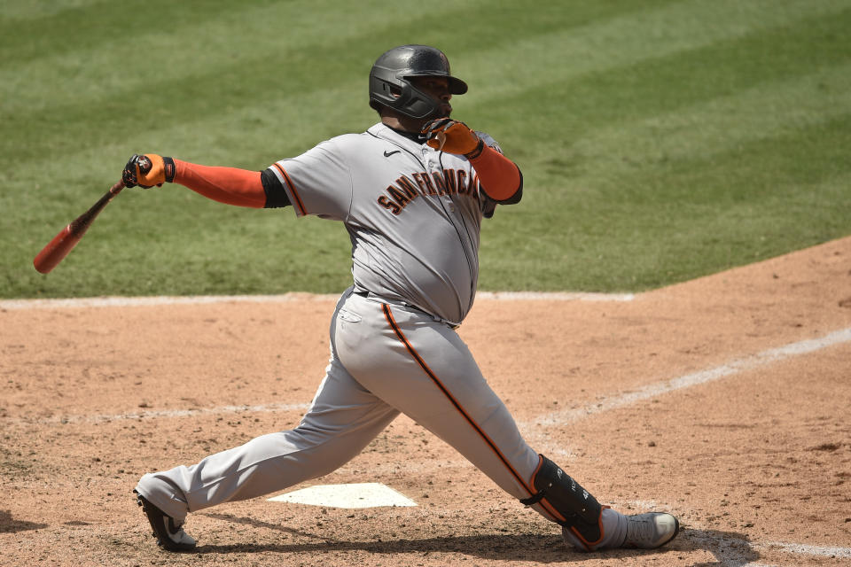 FILE - San Francisco Giants designated hitter Pablo Sandoval follows through on a swing during the fifth inning of a baseball game against the Los Angeles Angels in Anaheim, Calif., Tuesday, Aug. 18, 2020. Sandoval, the 2012 World Series MVP, is returning to the San Francisco Giants on a minor league deal that includes an invitation to major league camp. (AP Photo/Kelvin Kuo, File)