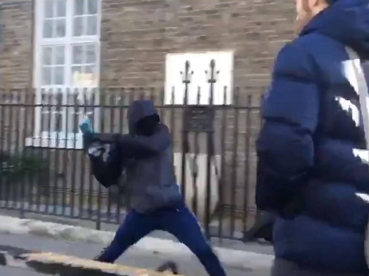 Screen grab of a group of four youngsters using an angle grinder to steal a bike outside London Fields Primary School in Hackney, east London: Screen grab/Twitter/@jonestowncoffee