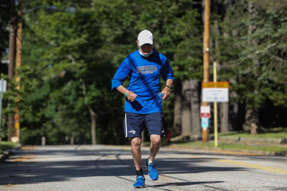 Hopedale running coach, Joe Drugan, then 76, runs a "Crush Corona" 5K starting at Hopedale Memorial Elementary School on Jun. 12, 2020. The 5K was setup to honor and celebrate those people over 70 who have suffered or lost their lives during the coronavirus pandemic.