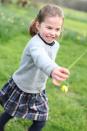 <p>Here's another photo from the set, which shows Charlotte picking a flower. </p>