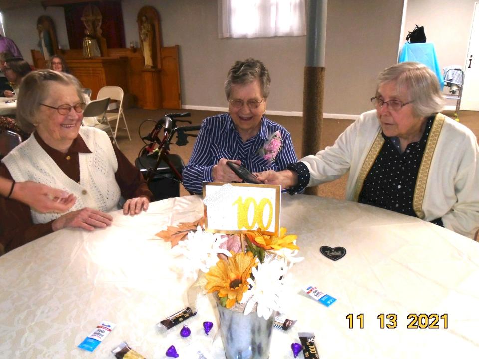 Sisters (from left to right) Julia Kopriva, 104, Frances Kompus, age 100, and Lucy Pochop, 102, of Atwood, Kansas, celebrate Frances'' 100th birthday on Nov. 11, 2021.