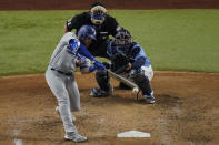 Los Angeles Dodgers first baseman Max Muncy hits a home run against the Tampa Bay Rays during the fifth inning in Game 5 of the baseball World Series Sunday, Oct. 25, 2020, in Arlington, Texas. (AP Photo/Sue Ogrocki)