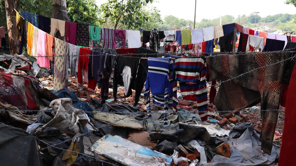 Clothes hanging to dry near demolished houses opposite Pragati Maidan.  - Rhea Mogul/CNN