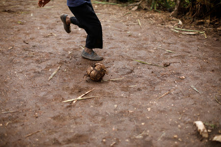 A boy plays with an improvised ball in Boucan Ferdinand, Haiti, October 10, 2018. REUTERS/Andres Martinez Casares