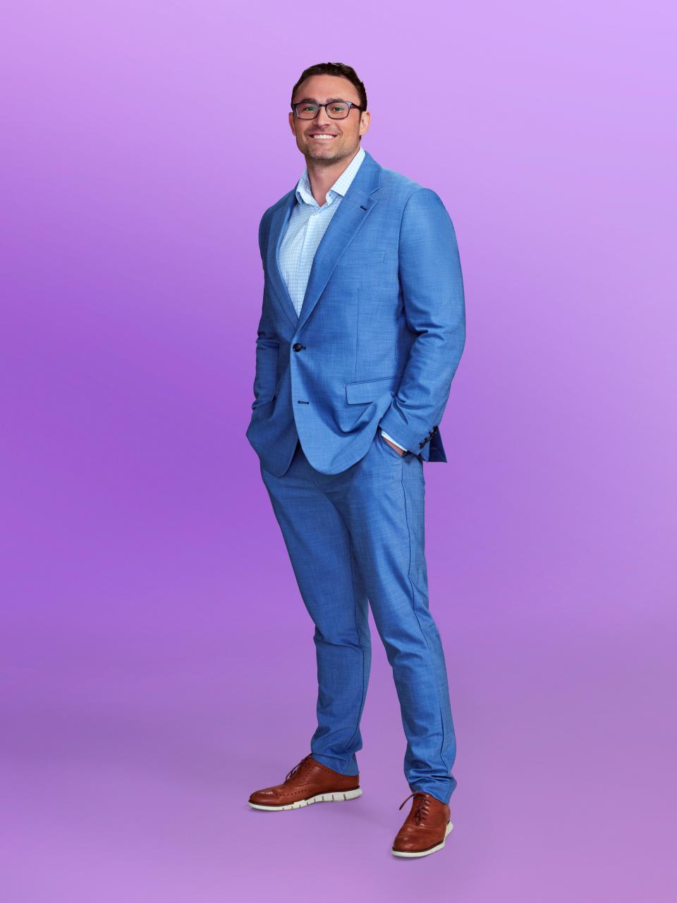 Matthew, a contestant on "Love Is Blind" season 6, wearing a blue suit and glasses