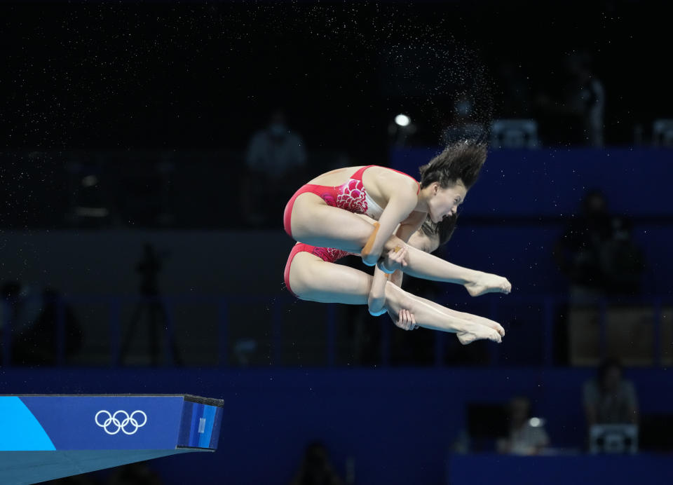 Yuxi Chen and Jiaqi Zhang of China compete during the women's synchronized 10m platform diving final at the Tokyo Aquatics Centre at the 2020 Summer Olympics, Tuesday, July 27, 2021, in Tokyo, Japan. (AP Photo/Dmitri Lovetsky)