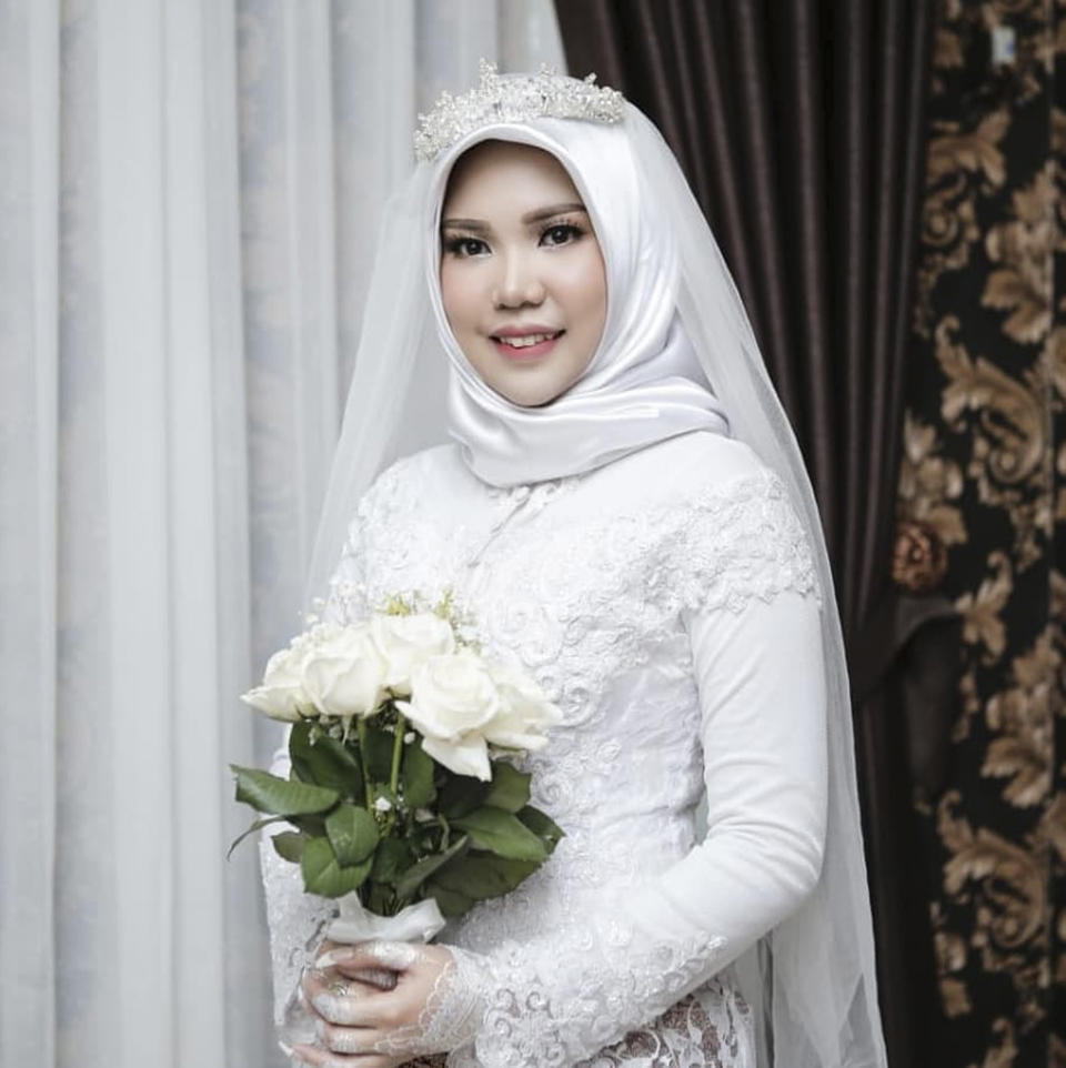 In this photo taken on Sunday, Nov. 11, 2018, and released by Intan Syari, Indonesian Intan Syari poses in her wedding dress with a bouquet of flowers on the day of her planned wedding in Pangkal Pinang, Indonesia. Syari who was engaged to a man who died on a Lion Air flight that plunged into the sea has worn her wedding dress on the day they were to have been married. Intan Syari's fiance, medical doctor Rio Nanda Pratama, was among 189 people on the Boeing 737 MAX 8 plane who died when it crashed a few minutes after taking off from Jakarta on Oct. 29. (AP Photo)