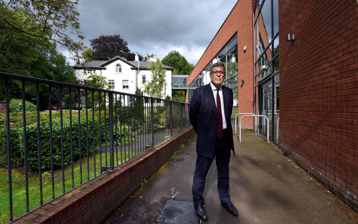 Van Mourik Broekman stood next to a more modern red brick building