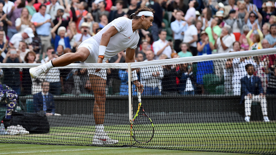 Rafael Nadal climbs over the net to console Juan Martin Del Potro at Wimbledon. Pic: Getty