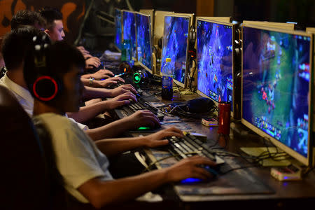 FILE PHOTO: People play online games at an internet cafe in Fuyang, Anhui province, China August 20, 2018. REUTERS/Stringer