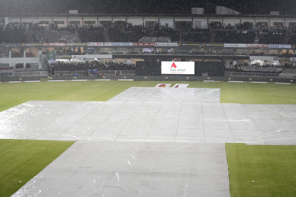 Pitch covers with sheets as rain stop the play of first T20 cricket match between Pakistan and New Zealand, in Rawalpindi, Pakistan, Thursday, April 18, 2024. (AP Photo/Anjum Naveed)