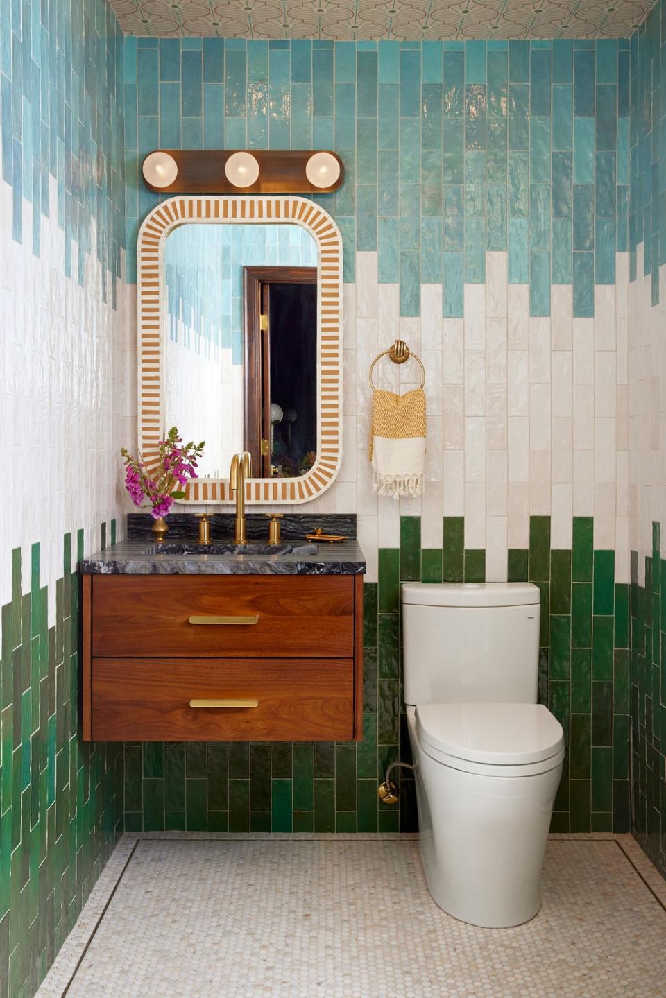 David imagined the primary bathroom as an Elysian field. “I could picture myself running gleefully, with soft grass beneath my feet and a cloud-dappled sky above,” he recounts. That little daydream led to a tricolored bathroom with blue, white, and green wall tile and a shimmering penny-tiled floor. The vanity is from Rejuvenation, and the mirror and lighting are Etsy finds.