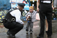 A police officer speaks to a child resident of the Dale Farm travellers' settlement at the camp's entrance on the night before the eviction on September 18, 2011 in Basildon, England. Various court appeals to prevent the eviction of travellers from a portion of the camp without planning permission have failed.