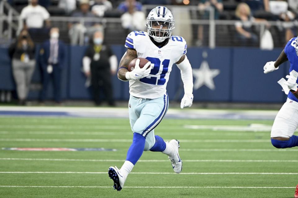 Dallas Cowboys running back Ezekiel Elliott runs upfield.