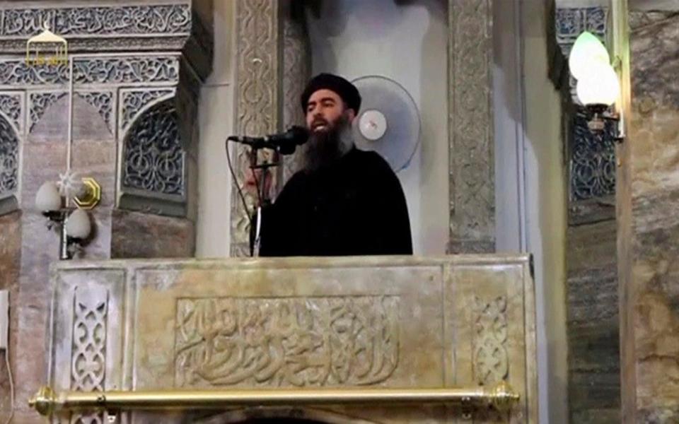 A man purported to be the reclusive leader of the militant Islamic State Abu Bakr al-Baghdadi making what would have been his first public appearance, at a mosque in the centre of Iraq's second city, Mosul, according to a video recording posted on the Internet on July 5, 2014 - Credit: Reuters