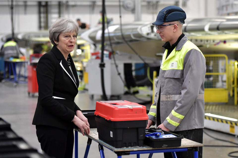 British Prime Minister Theresa May (L) speaks to Josh Barnes (R), an operations worker, during a visit to the Belfast Bombardier factory in Belfast on February 12, 2018.   May visited Belfast to speak to workers at Bombardier's Belfast facility and to engage with the main Northern Ireland political parties as they press ahead with efforts to agree the formation of an Executive.  / AFP PHOTO / POOL / Charles McQuillan        (Photo credit should read CHARLES MCQUILLAN/AFP/Getty Images)
