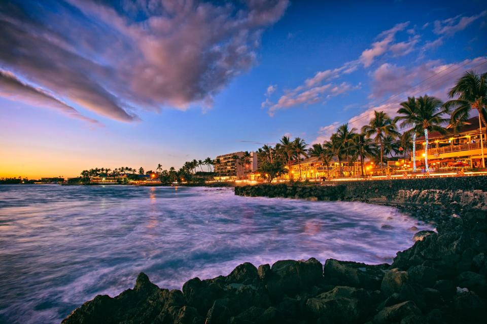 the sun sets along alii drive on the beach town of kailua kona on the big island of hawaii