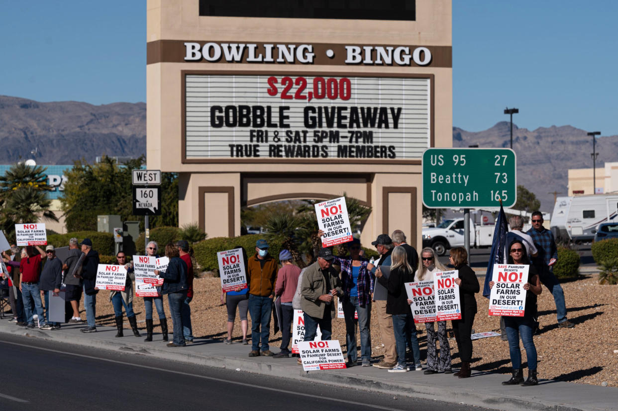 Attendees hold signs at a rally to protest solar development in Pahrump, Nev., on Nov. 27, 2021. (Bridget Bennett for NBC News)