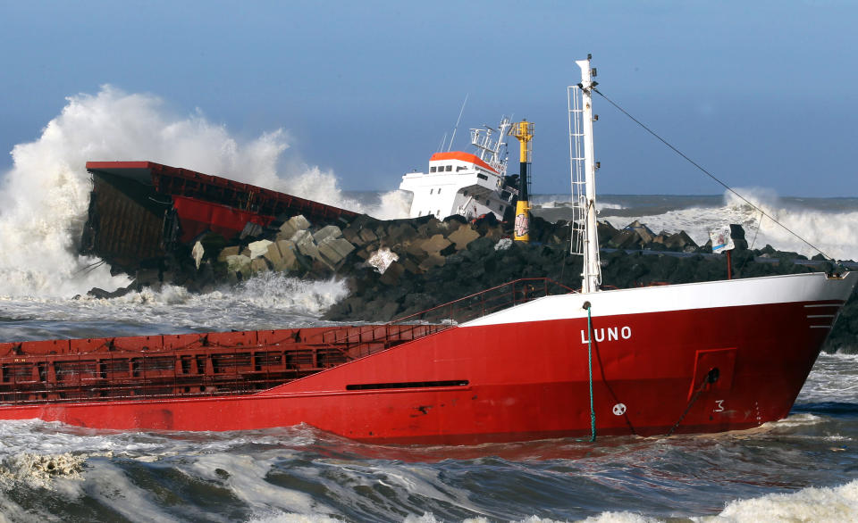 Waves knock against the wreck of the Spanish cargo ship "Luno" that slammed into a jetty in choppy Atlantic Ocean waters and broke in two, off Anglet, southwestern France, Wednesday, Feb. 5, 2014. The ship had been heading to a nearby port to load up with cargo when its engine failed and the rough waves carried it into the jetty. (AP Photo/Bob Edme)