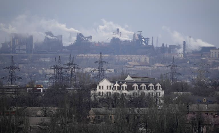 FILE - A metallurgical plant is seen on the outskirts of the city of Mariupol, Ukraine, Thursday, Feb. 24, 2022. Russia began evacuating its embassy in Kyiv, and Ukraine urged its citizens to leave Russia. Russian President Vladimir Putin ordered his forces not to storm the last remaining Ukrainian stronghold in the besieged city of Mariupol but to block it "so that not even a fly comes through." Defense Minister Sergei Shoigu told Putin on Thursday that the sprawling Azovstal steel plant where Ukrainian forces were holed up was "securely blocked." (AP Photo/Sergei Grits, File)