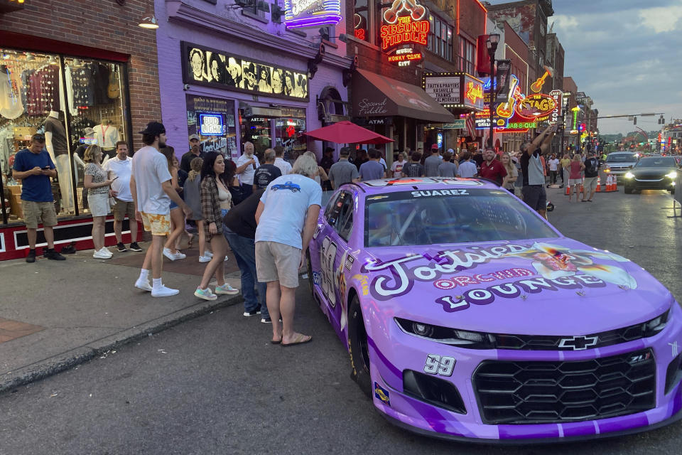 The No. 99 Chevrolet driven by Daniel Suarez for Trackhouse Racing is displayed outside Tootsie’s Orchid Lounge in Nashville, Tenn., Thursday, June 17, 2021. Trackhouse hopes to be operating from downtown Nashville by 2023 and Marks is using Sunday’s first Cup race in the market in 37 years to lay the groundwork for his move. (AP Photo/Jenna Fryer)