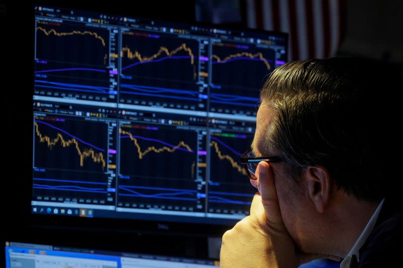 FILE PHOTO: A trader works on the floor of the NYSE in New York