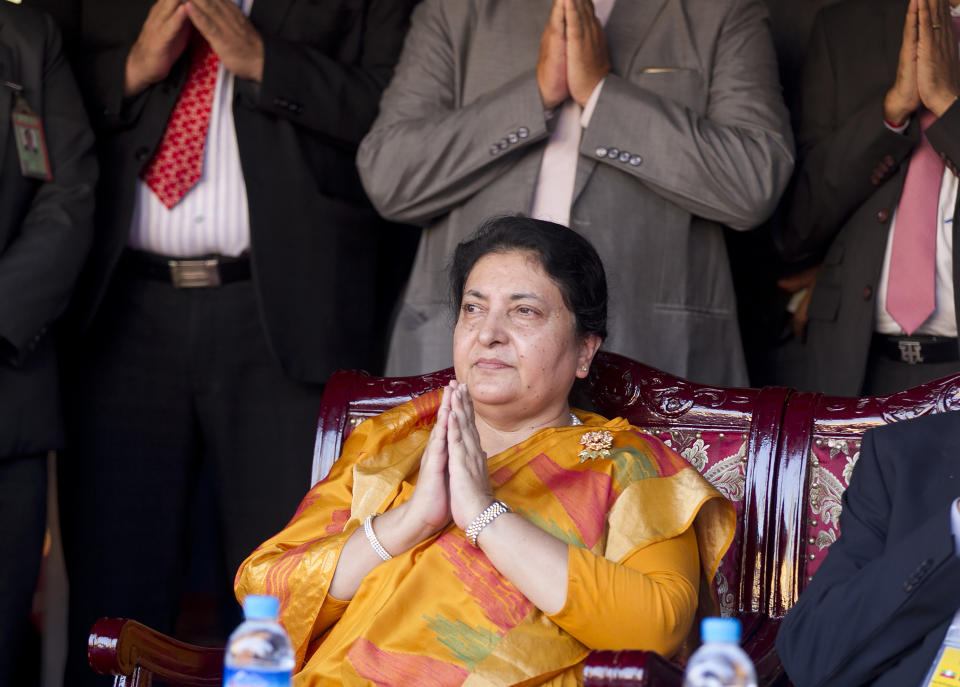 Nepali President Bidya Devi Bhandari pays respect during the opening ceremony of a traveling exhibition on Lumbini, Nepal in Yangon, Myanmar on Oct. 19, 2019. Nepal's president has dissolved Parliament after the prime minister made the recommendation amid an escalating feud within his Communist Party that is likely to push the Himalayan nation into a political crisis. Parliamentary elections will be held on April 30 and May 10, according to a statement from Bhandari's office. (AP Photo/Thein Zaw)