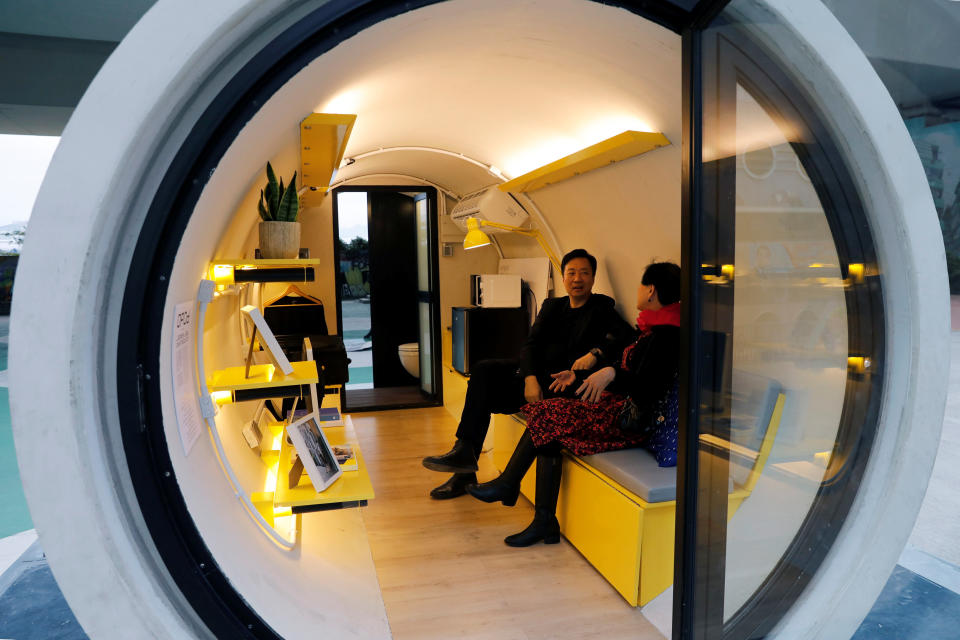 James Law sits inside the neat, functional apartment of the future (REUTERS/Tyrone Siu)