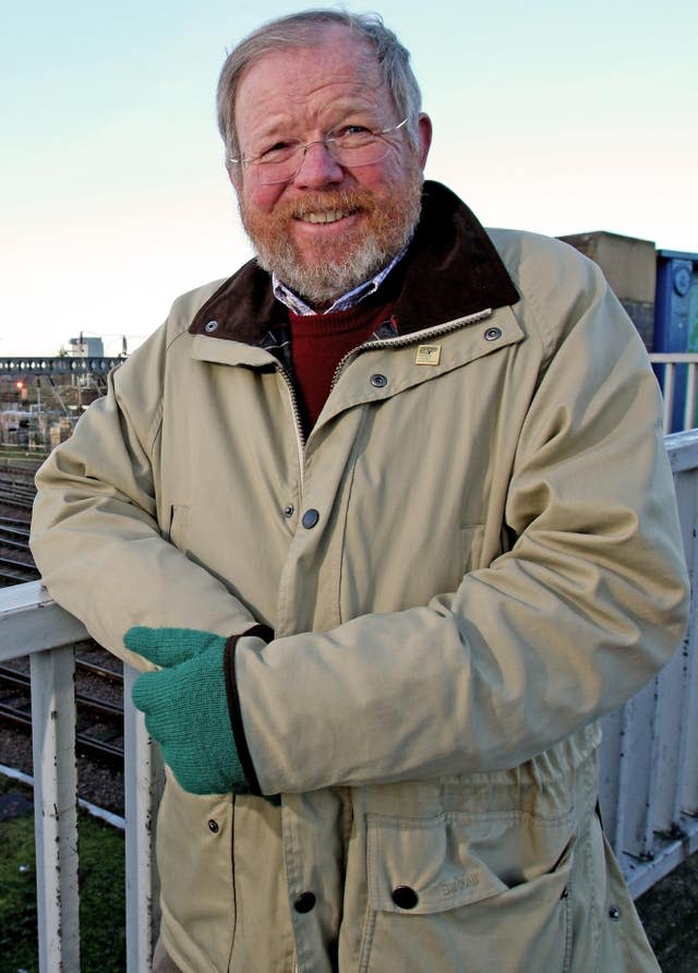 Author Bill Bryson stands alongside the railway track 