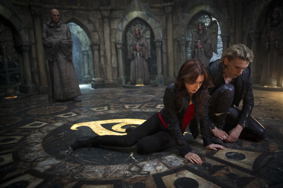 This film publicity image released by Screen Gems shows Jamie Campbell Bower as Jace, right, and Lilly Collins as Clary in a scene from "The Mortal Instruments: City of Bones. (AP Photo/Sony Pictures Screen Gems, Rafy)