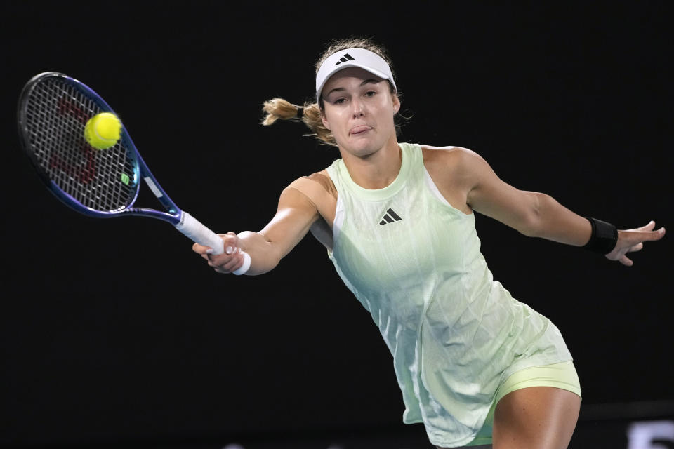 Anna Kalinskaya of Russia plays a forehand return to Zheng Qinwen of China during their quarterfinal match at the Australian Open tennis championships at Melbourne Park, Melbourne, Australia, Wednesday, Jan. 24, 2024. (AP Photo/Alessandra Tarantino)