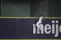 Milwaukee Brewers' Jackie Bradley Jr. makes a leaping catch at the wall on a ball hit by Atlanta Braves' Ozzie Albies during the seventh inning of a baseball game Saturday, May 15, 2021, in Milwaukee. (AP Photo/Aaron Gash)