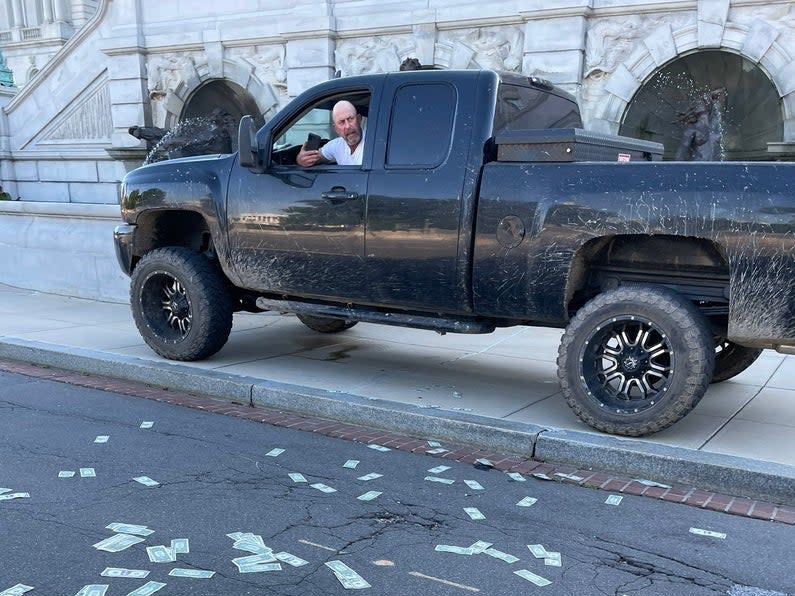 An eyewitness photo from near the Library of Congress shows the alleged suspect threatening the Capitol area with potential explosives. (Sydney Bobb)