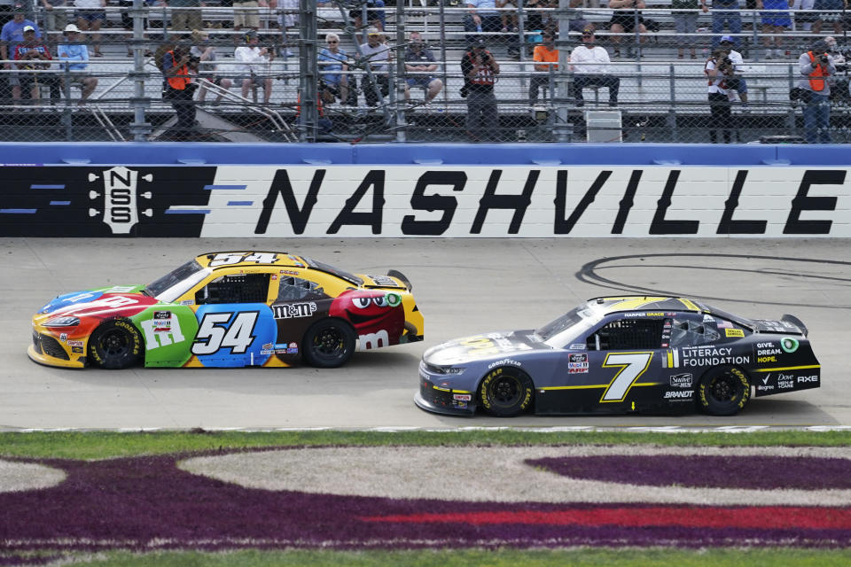 Kyle Busch (54) leads Justin Allgaier (7) during a NASCAR Xfinity Series auto race at Nashville Superspeedway, Saturday, June 19, 2021, in Lebanon, Tenn. (AP Photo/Mark Humphrey)