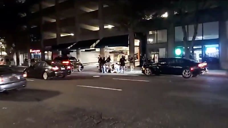 People surround a victim of a shooting in Portland, Oregon