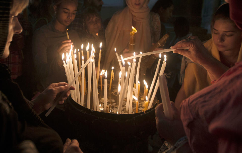 Candles lit at the tomb of Jesus Christ in Jersusalem, Israel