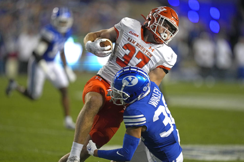 BYU safety Crew Wakley (38) tackles Sam Houston State tight end Jax Sherrard (37) during the first half of an NCAA college football game Saturday, Sept. 2, 2023, in Provo, Utah. (AP Photo/Rick Bowmer)