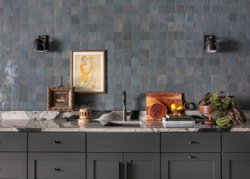 A tiled backsplash and graphic countertop create movement and intrigue in the kitchen