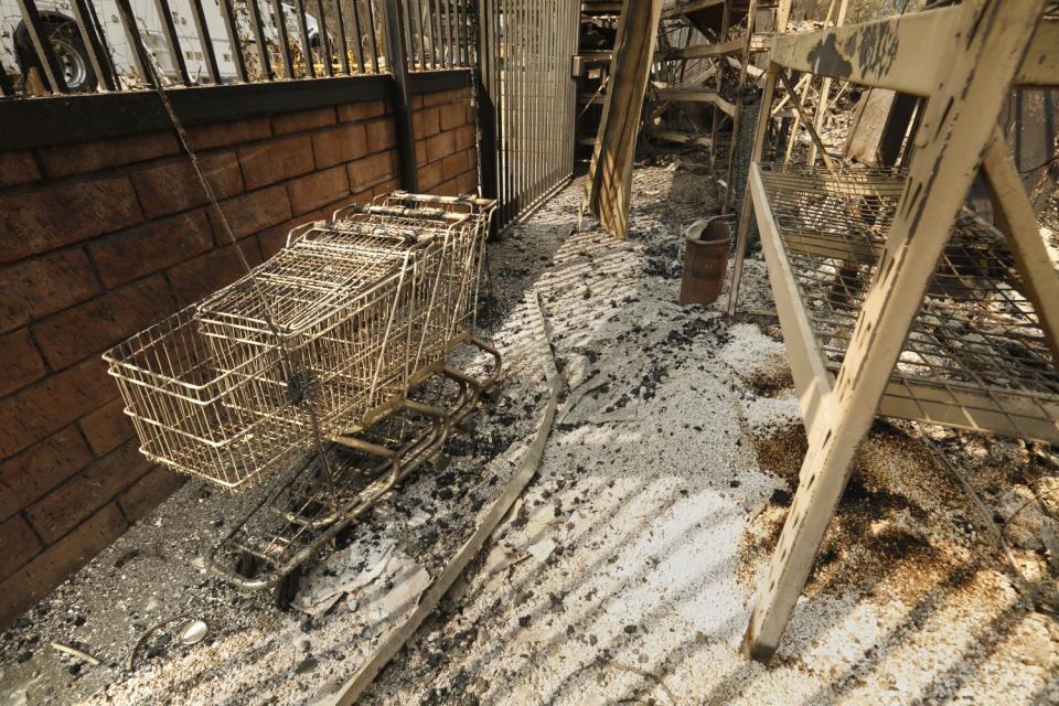 All that remains of the Village Market in Berry Creek, CA, are a few cans and carts.