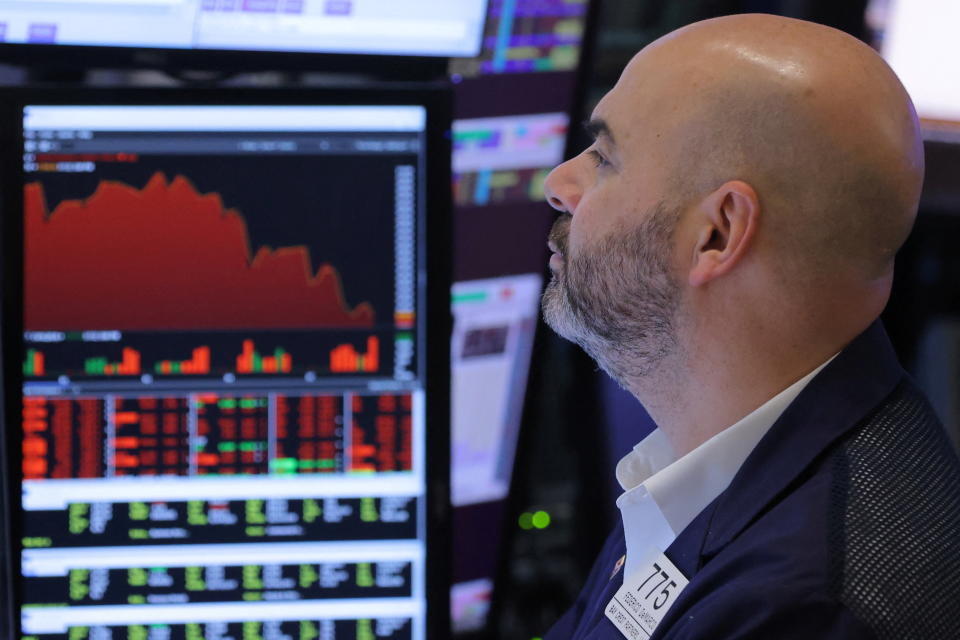 A trader works on the trading floor at the New York Stock Exchange (NYSE) in Manhattan, New York City, U.S., March 7, 2022. REUTERS/Andrew Kelly