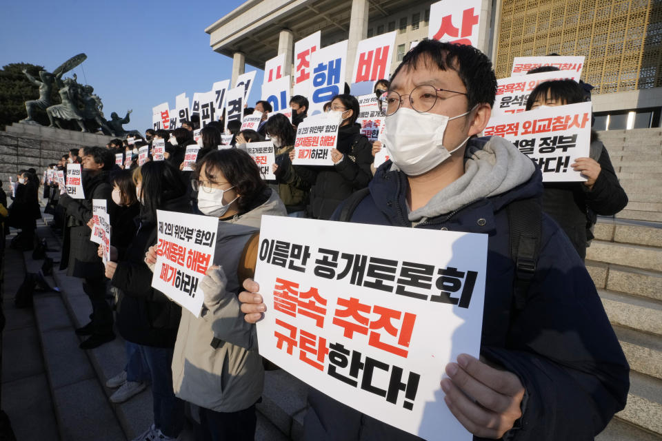 Members of a civic group seeking compensation from Japanese firms over forced labor during World War II and opposition lawmakers stage a rally to oppose the government's reported resolution to the issue outside the National Assembly in Seoul, Thursday, Jan. 12, 2023. The banners read "Apology and compensation from Japanese war criminal companies and condemn the government of President Yoon Suk Yeol." (AP Photo/Ahn Young-joon)