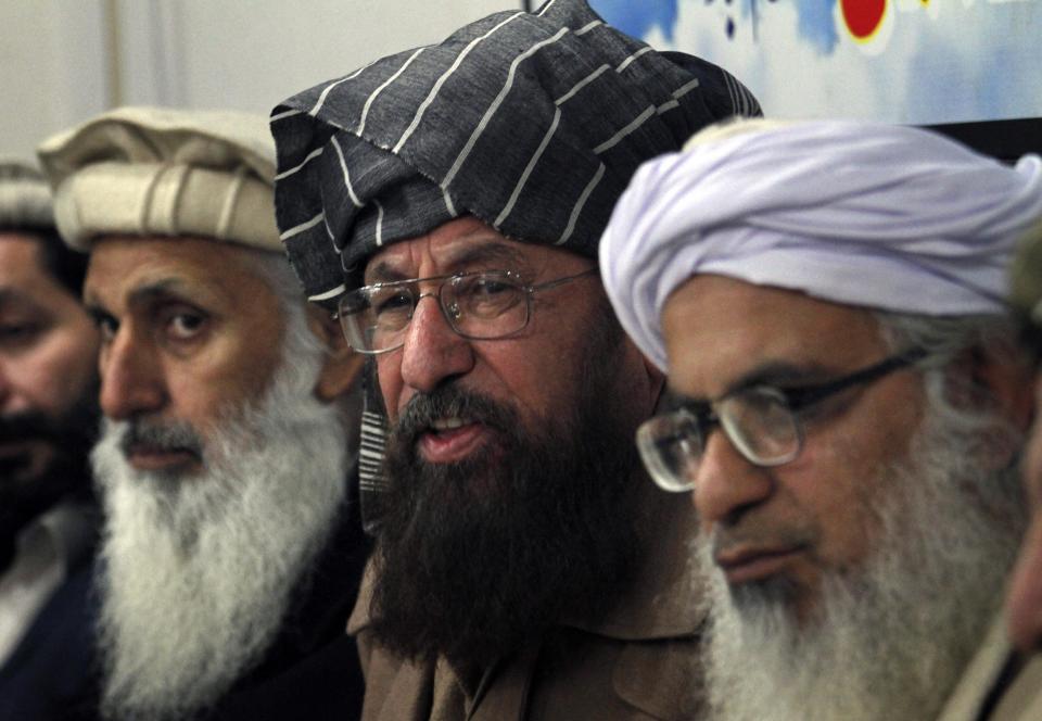 In this Monday, Feb. 3, 2014 photo, negotiators from Pakistani Taliban committee, from left, to right Ibrahim Khan, Maulana Sami-ul-Haq and Maulana Abdul Aziz, listen to a reporter during their press conference in Islamabad, Pakistan. The Pakistani government has recently opened negotiations with domestic militants called the Pakistani Taliban designed to end years of fighting in the northwest that has cost thousands of lives and forced hundreds of thousands of people to flee their homes. (AP Photo/Anjum Naveed)