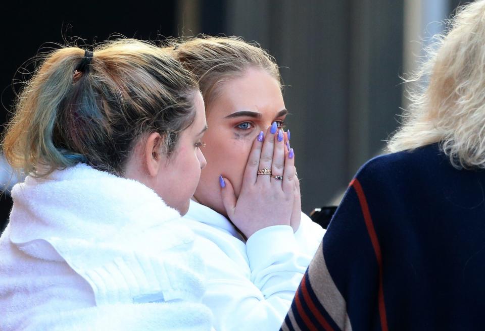 People react as they leave the Park Inn hotel that took in victims from the Manchester Arena.