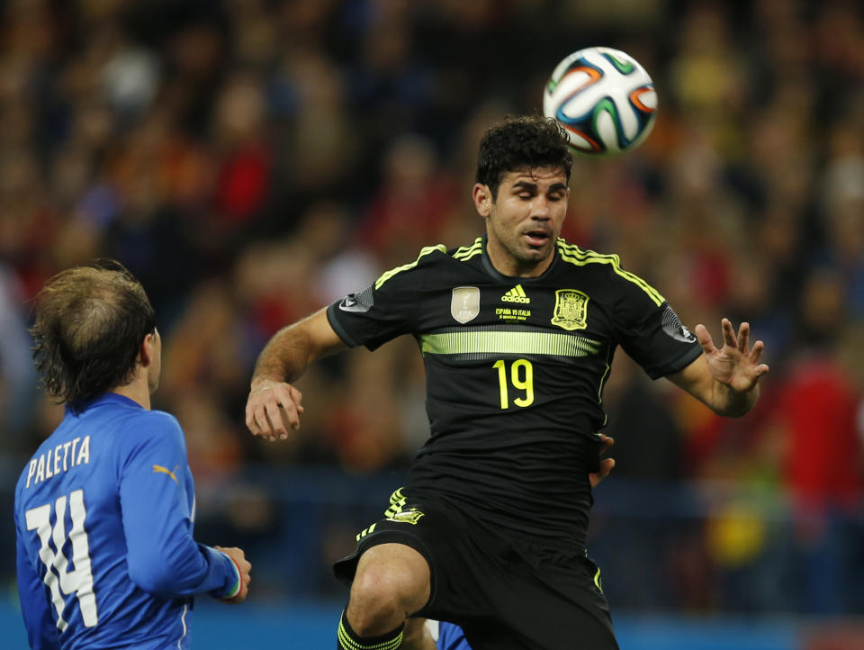 Spain's Diego Costa, right controls the ball in front of Italy's Gabriel Paletta during a friendly soccer match against Italy at the Vicente Calderon stadium in Madrid, Wednesday March 5, 2014. (AP Photo/Paul White)