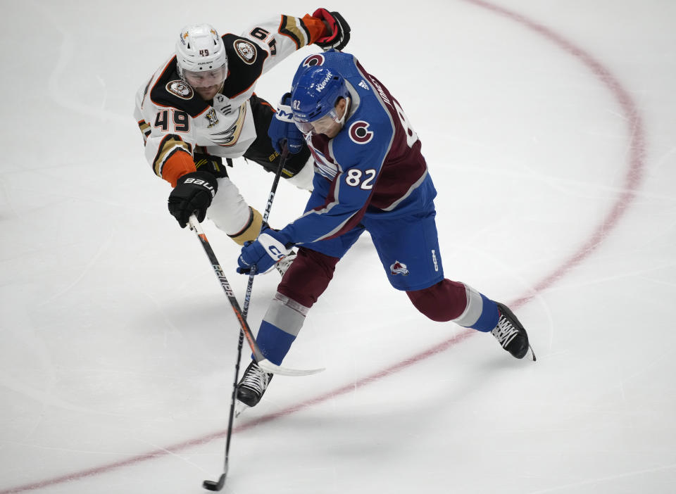 Colorado Avalanche defenseman Caleb Jones, right, clears the puck as Anaheim Ducks left wing Max Jones defends in the first period of an NHL hockey game Wednesday, Nov. 15, 2023, in Denver. (AP Photo/David Zalubowski)