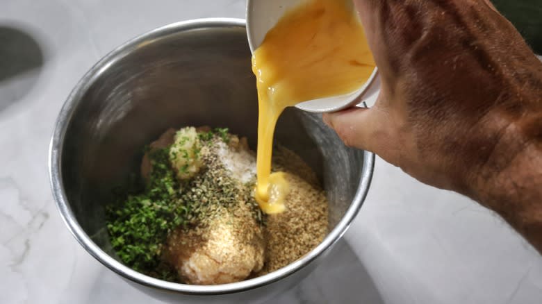 pouring beaten egg into mixing bowl