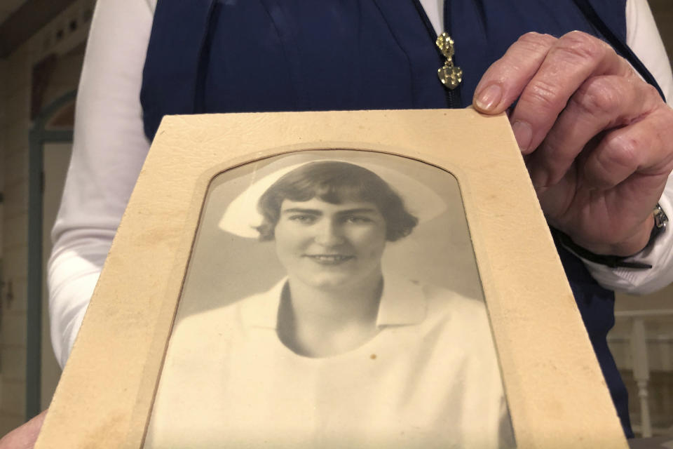 Nurse practitioner Sigrid Stokes, 76, holds a photograph of her mother at the Salinas Valley Memorial Hospital in Salinas, Calif., Wednesday, Feb. 3, 2021. Stokes is following in her family's footsteps during the pandemic. In 1918, Stokes' mother Kristine Berg Mueller was a 14-year-old hospital volunteer in Norway during the Spanish Flu pandemic, putting her in regular contact with the deadly disease. (AP Photo/Haven Daley)