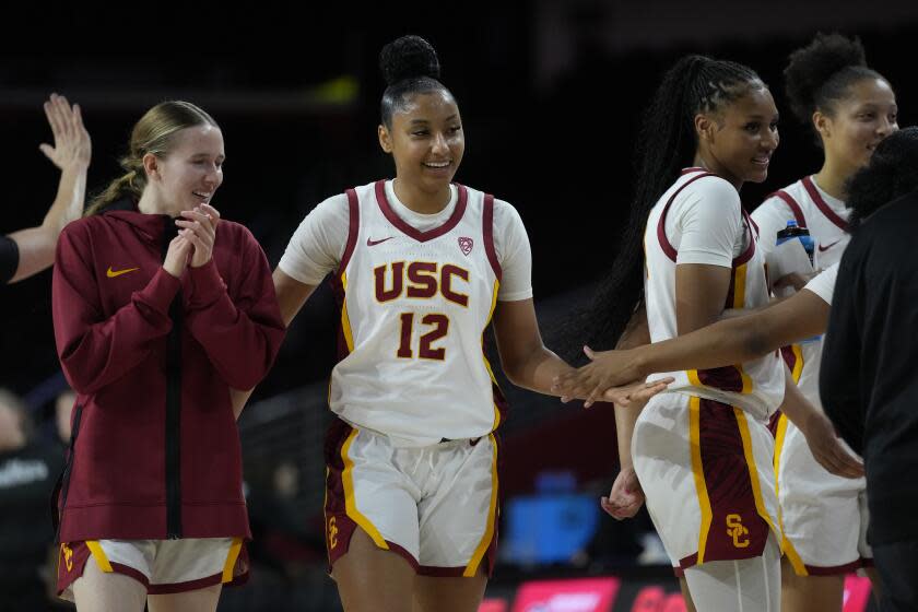 Southern California guard JuJu Watkins (12) celebrates with teammates during a timeout.