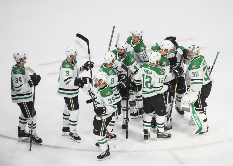 Dallas Stars players celebrate their 1-0 win over the Vegas Golden Knights after an NHL Western Conference final playoff hockey game, in Edmonton, Alberta, Sunday, Sept. 6, 2020. (Jason Franson/The Canadian Press via AP)
